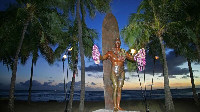 statue at sunset with torches