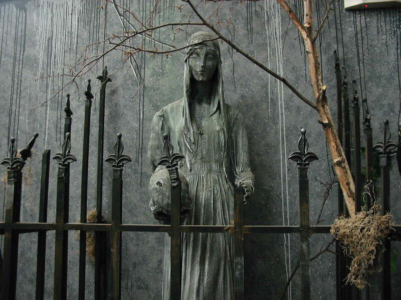 statue behind a fence