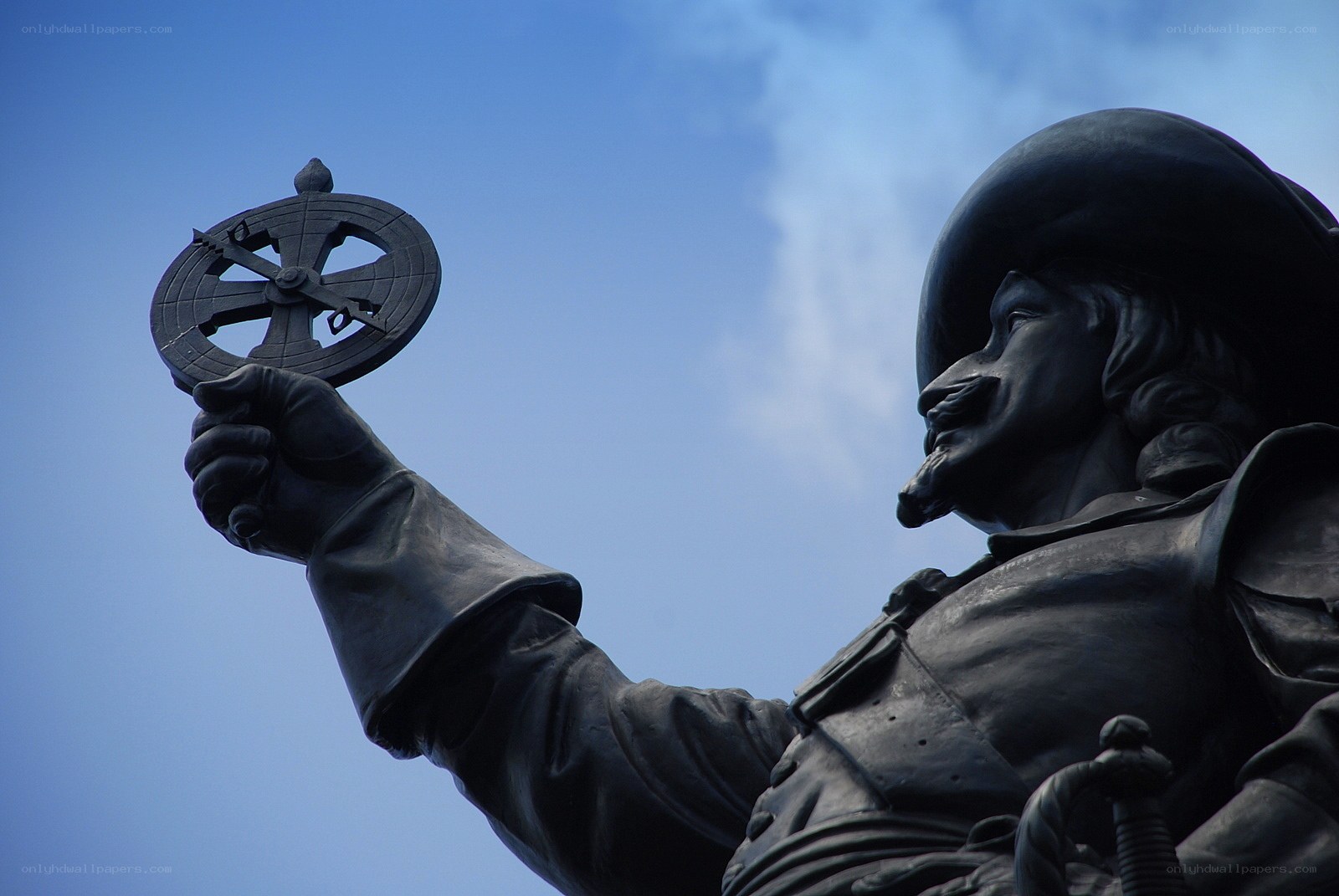 statue holding astrolabe