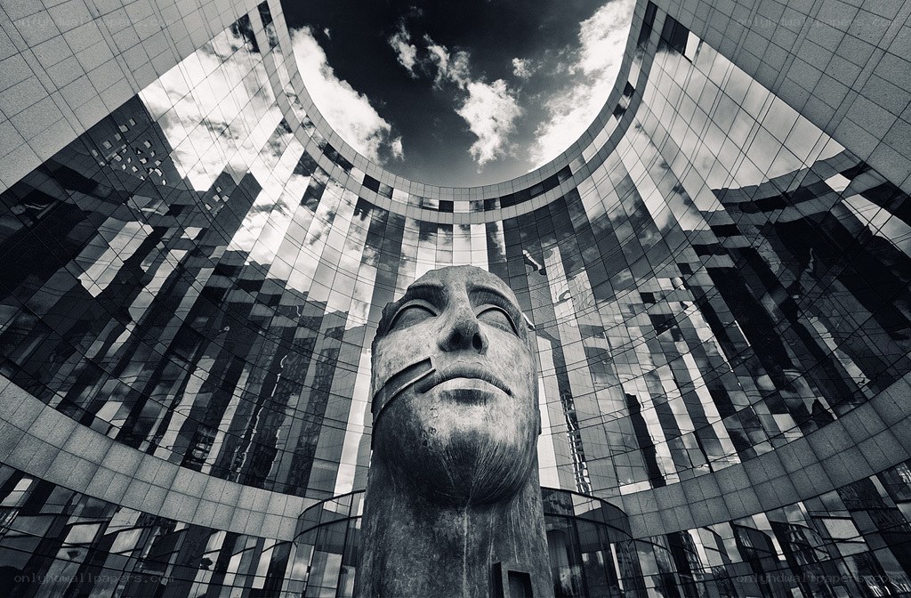 Statue in modern building courtyard
