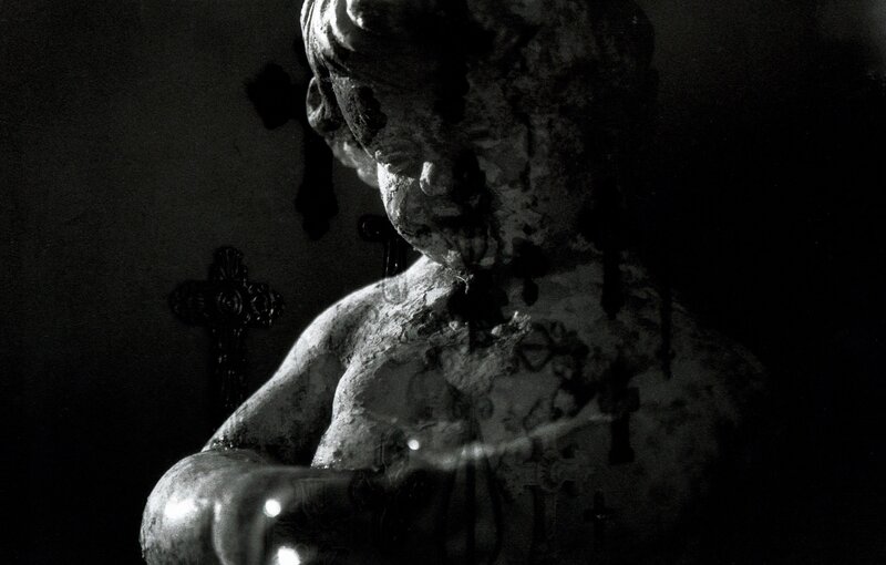 statue of a child with crosses