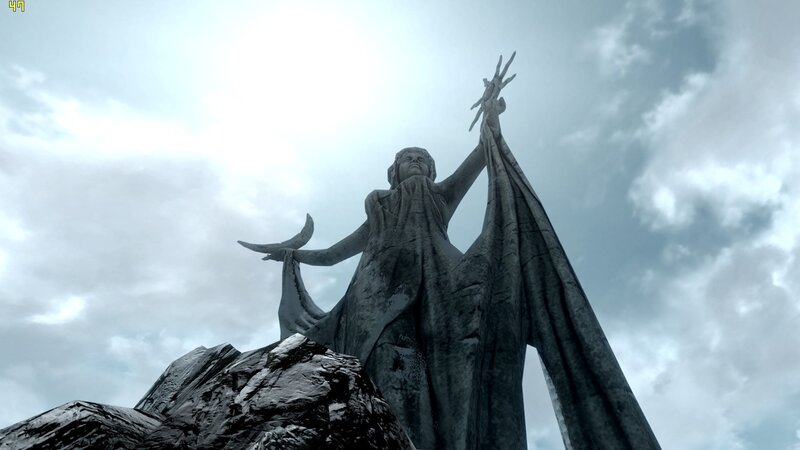 statue of a figure on a mountain