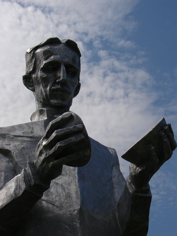 statue of a man holding book