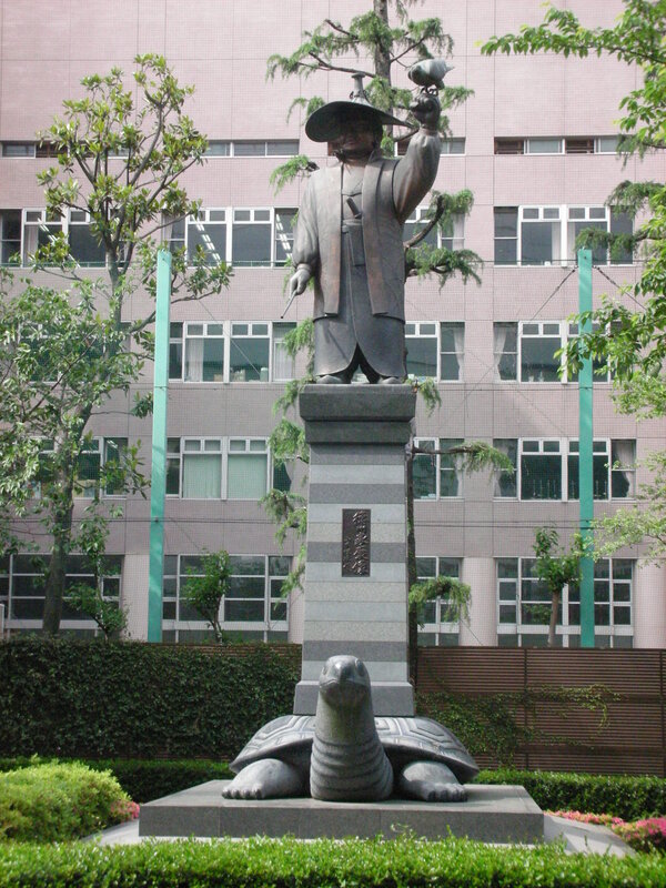 statue of a man with turtle