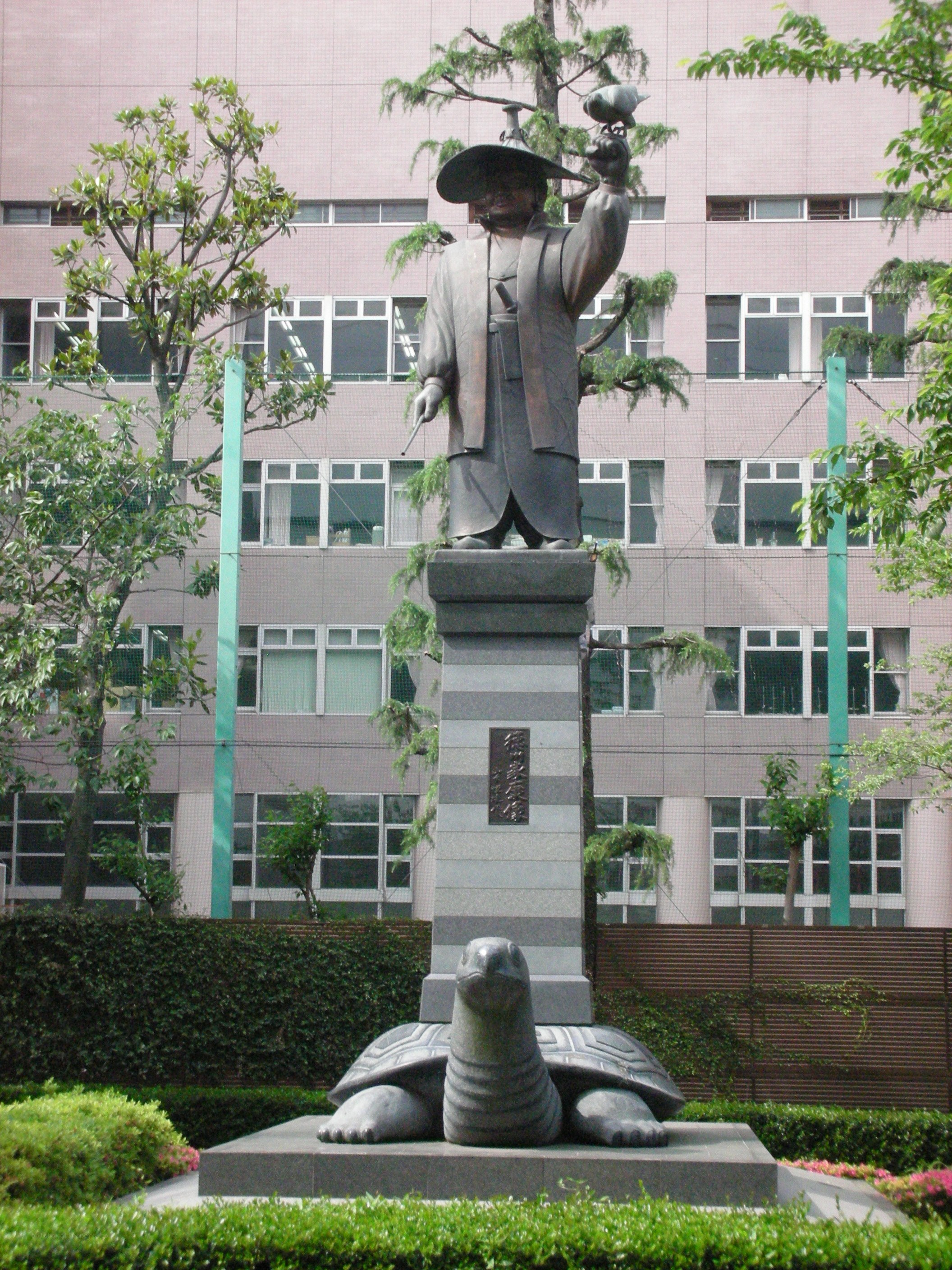 statue of a man with turtle