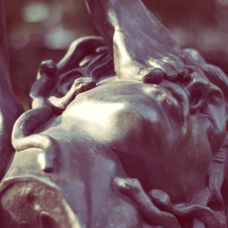 statue of a woman with snake