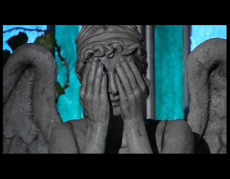 statue of angel covering face