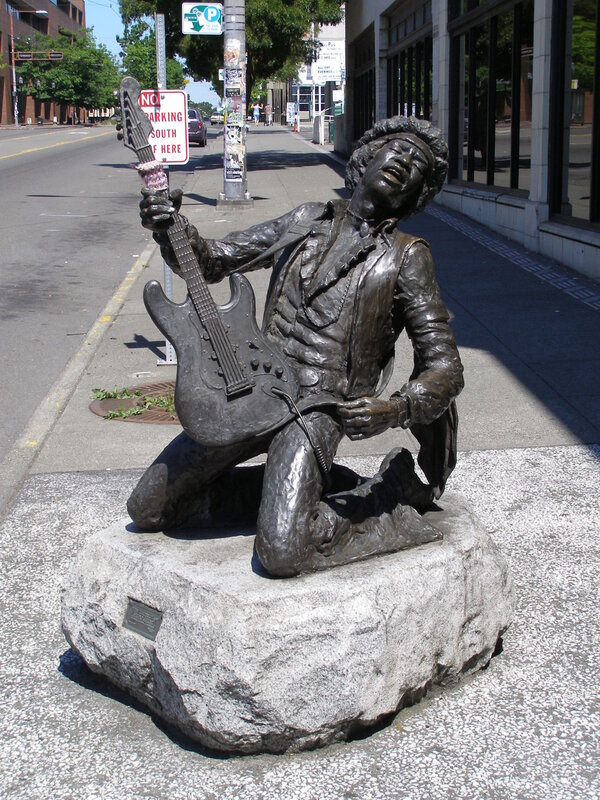statue of guitar player on street