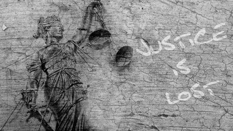 Statue of Justice with graffiti