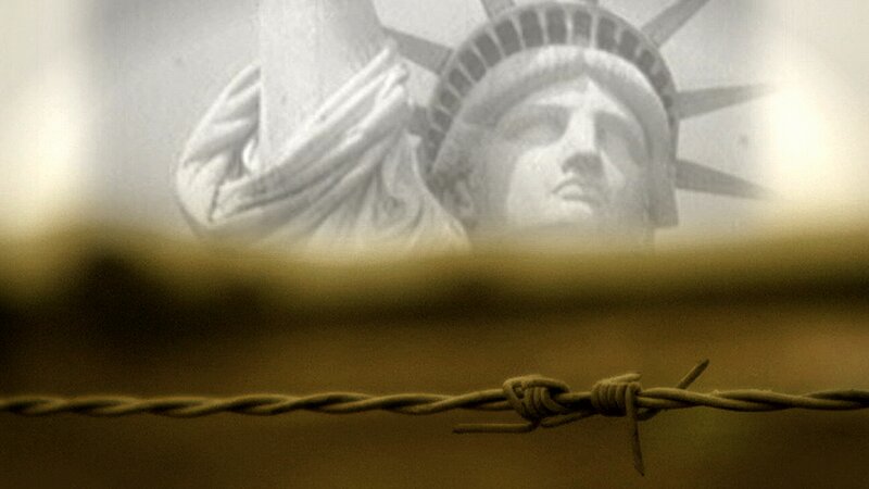 Statue of Liberty behind barbed wire