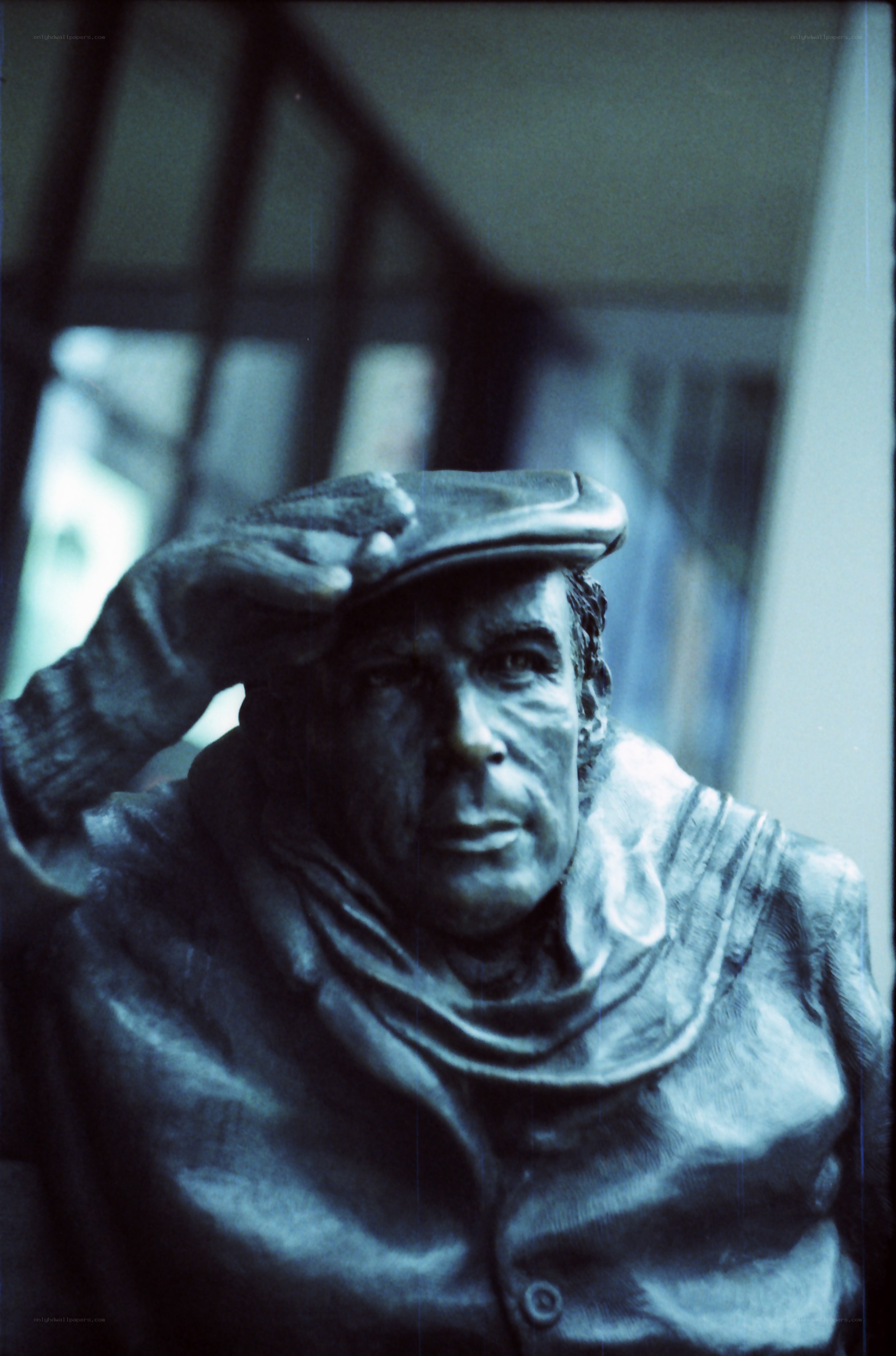 statue of man in cap