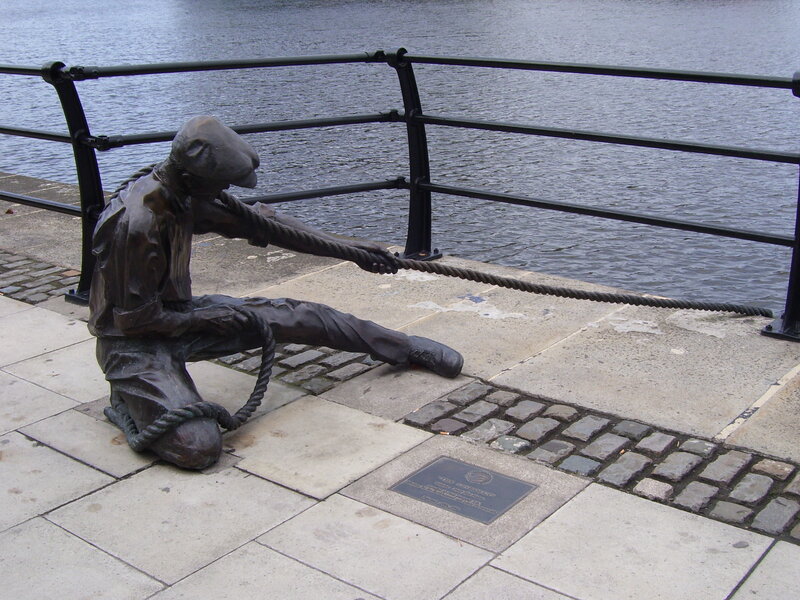 statue of sailor pulling rope