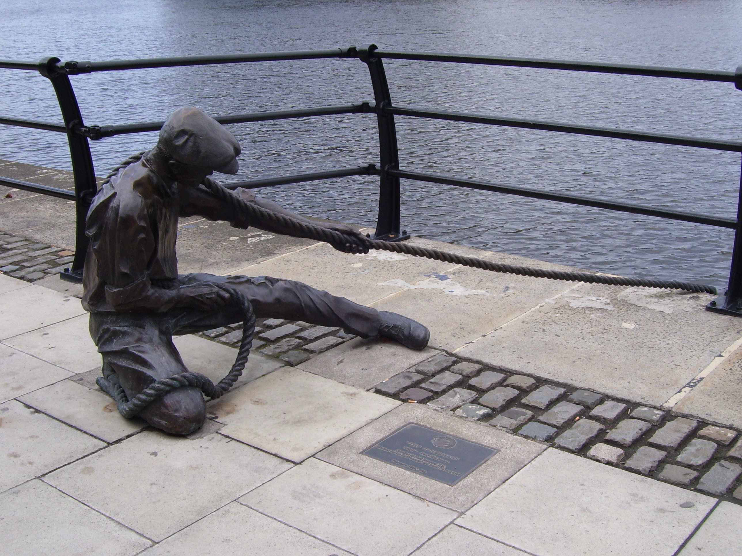 statue of sailor pulling rope