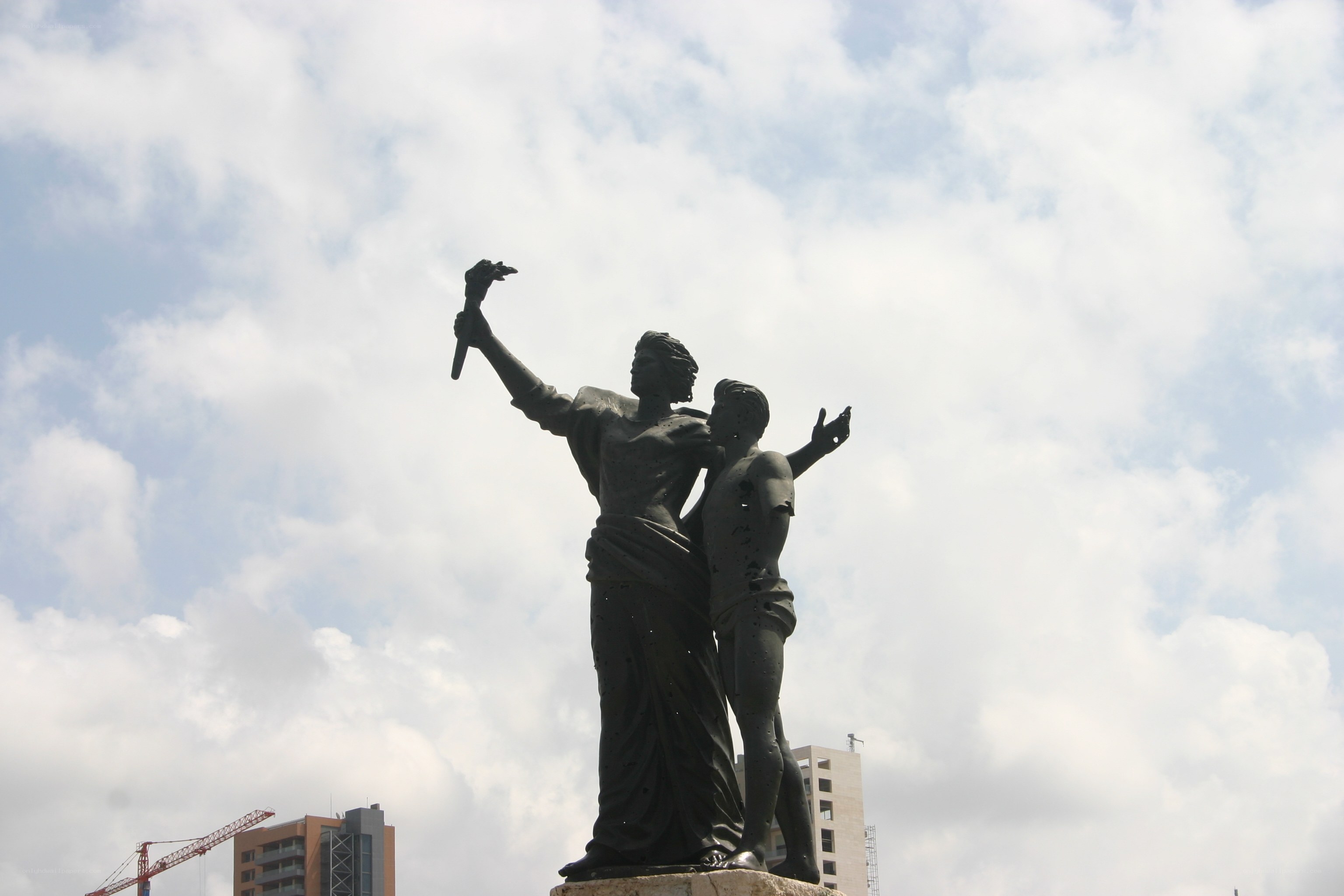 Statue of two figures with torch