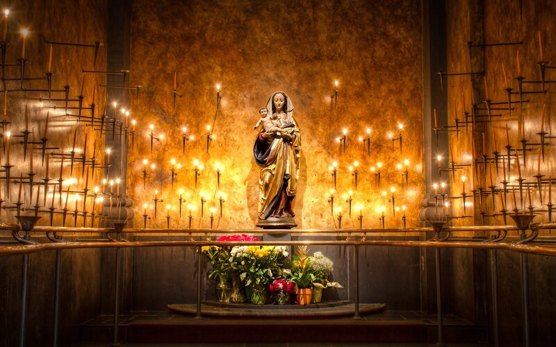 Statue of Virgin Mary with candles