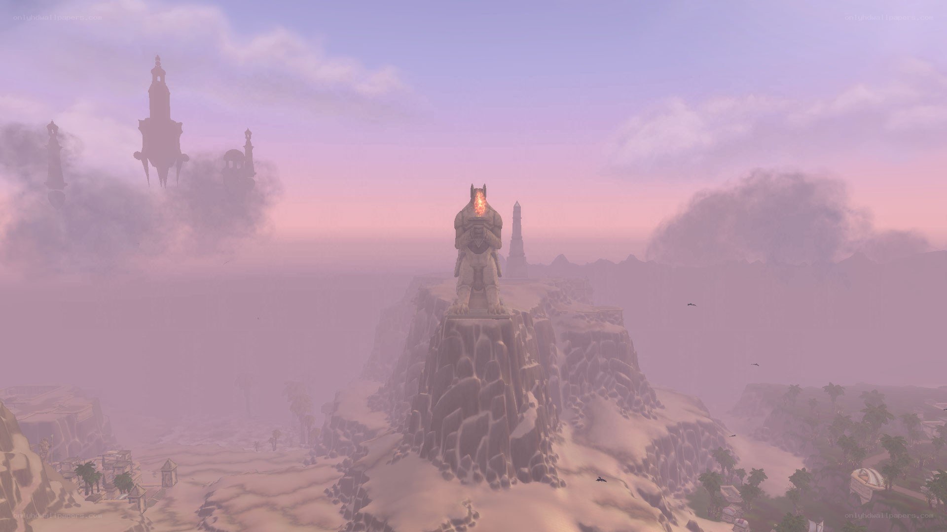 statue on a cliff at dusk
