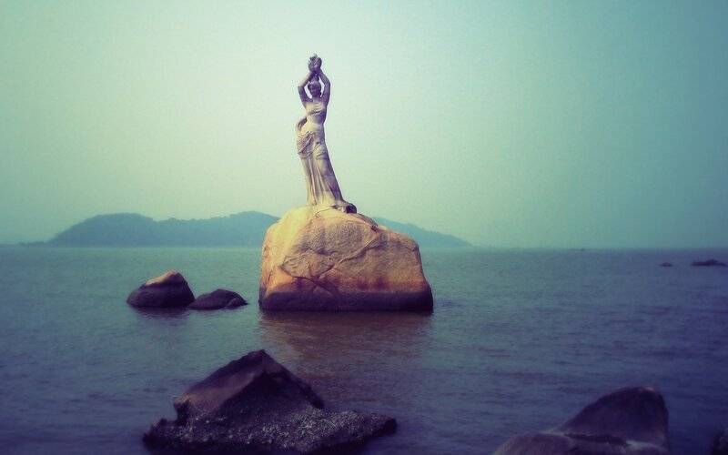 statue on a rock in the sea
