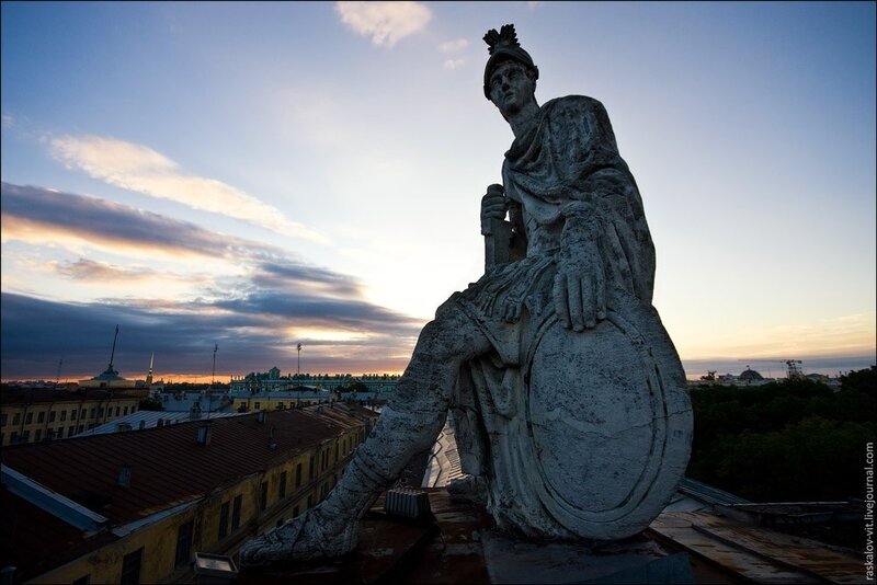 Statue on a rooftop at sunset