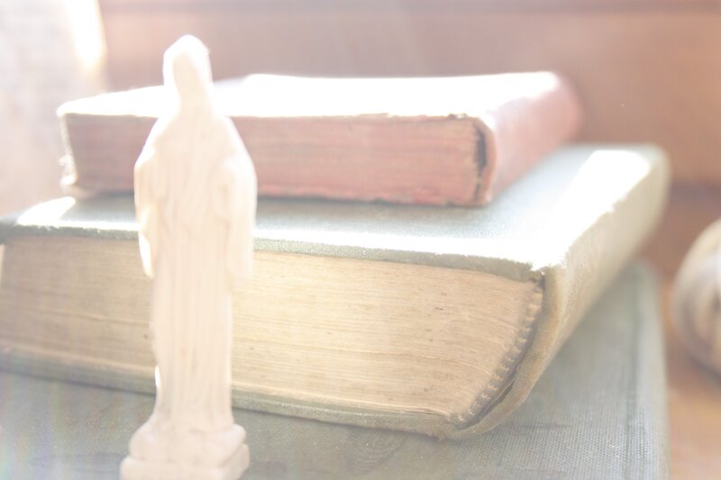 statue on old books
