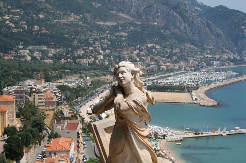 Statue overlooking a coastal city