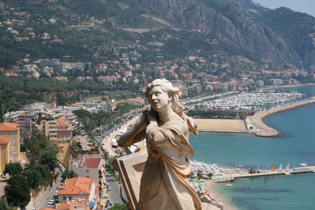 Statue overlooking a coastal city