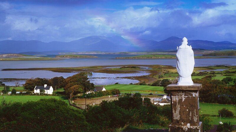 Statue overlooking a coastal landscape