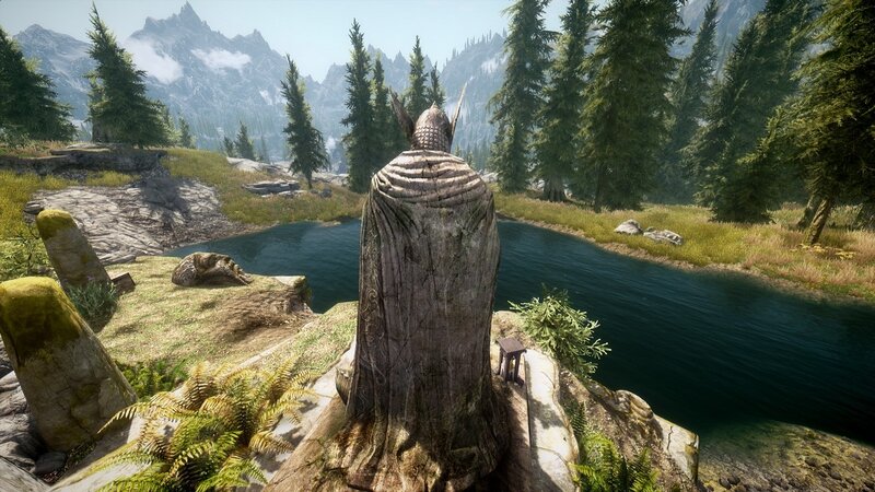statue overlooking a river