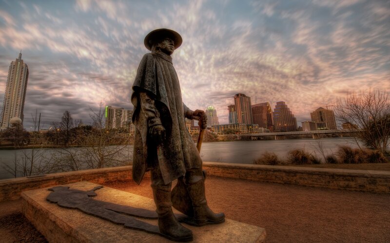 Statue overlooking city skyline