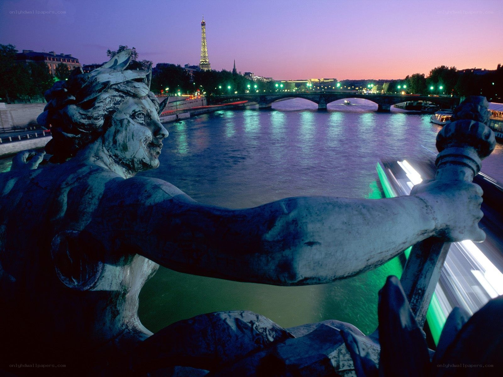 Statue overlooking Paris at dusk