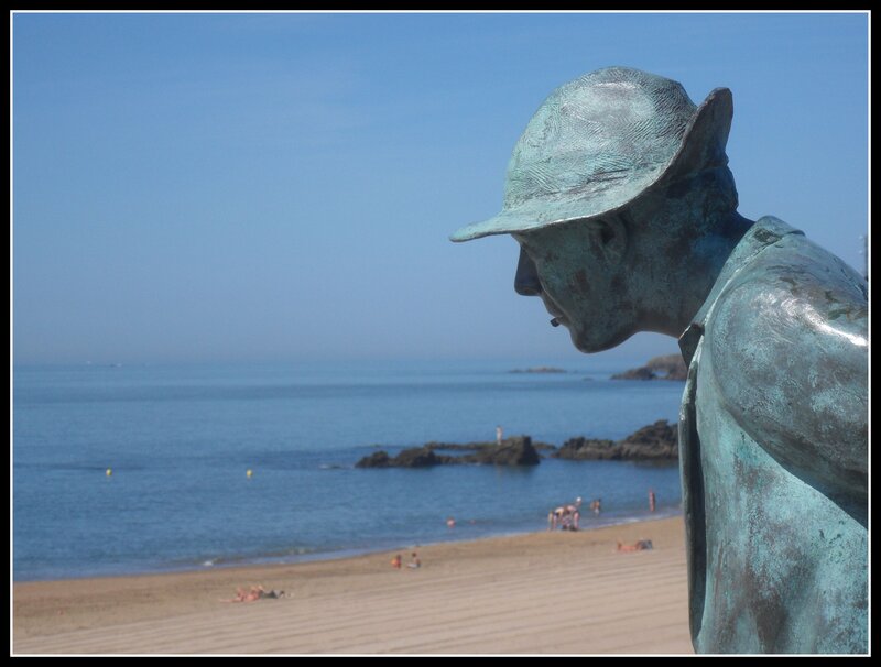statue overlooking the beach