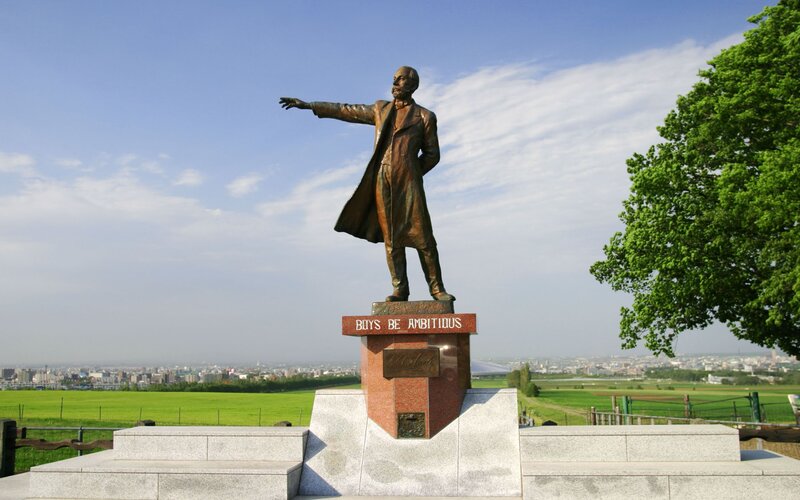statue with 'Boys Be Ambitious' inscription