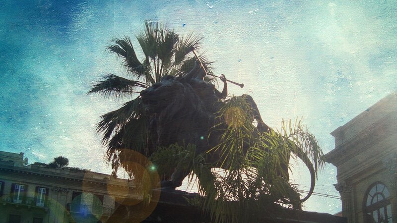 statue with palm trees