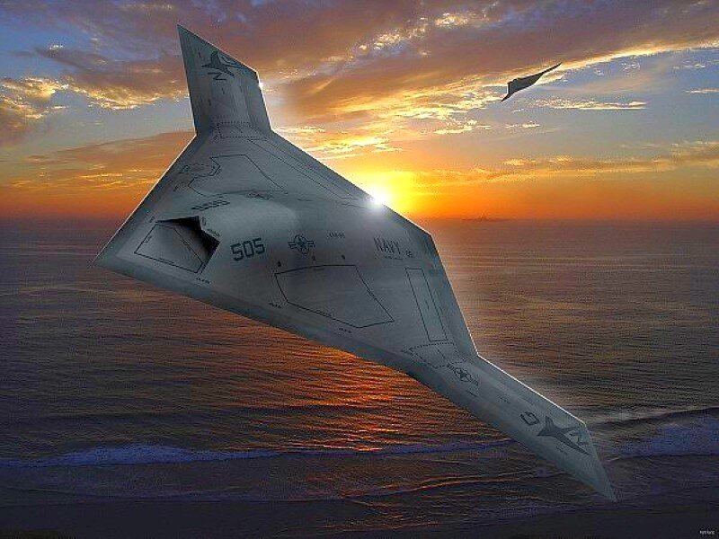 Stealth aircraft over ocean at sunset