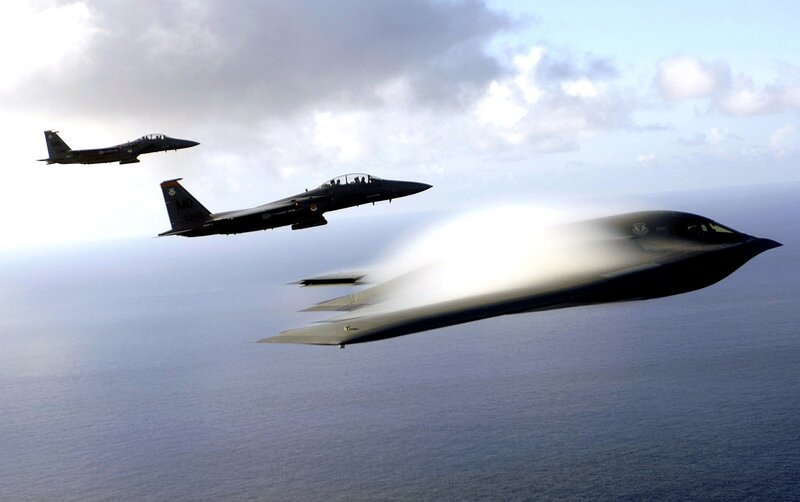 Stealth bomber with fighter escorts