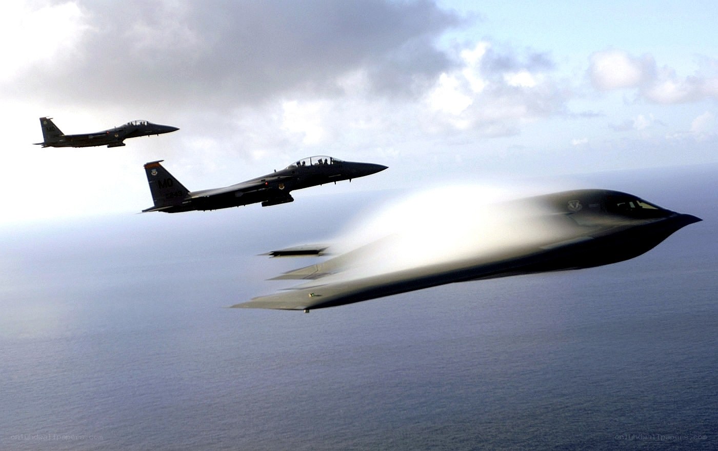 Stealth bomber with fighter escorts