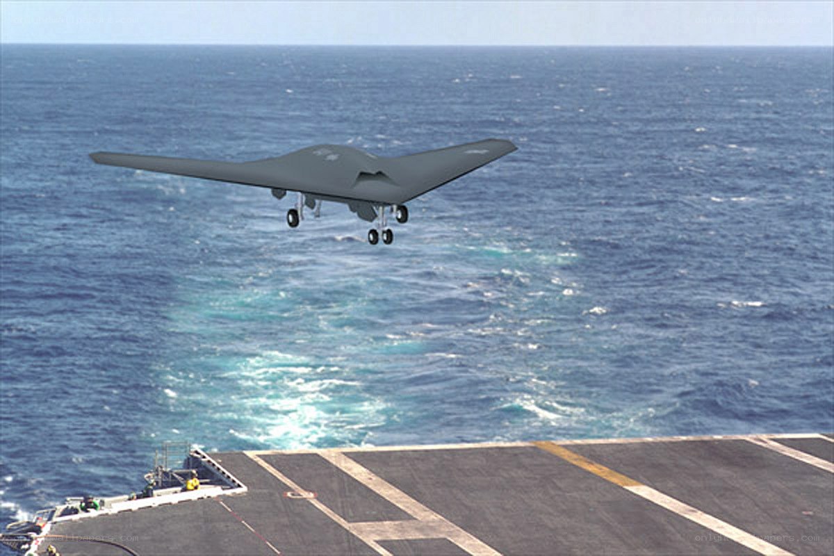 Stealth drone over aircraft carrier