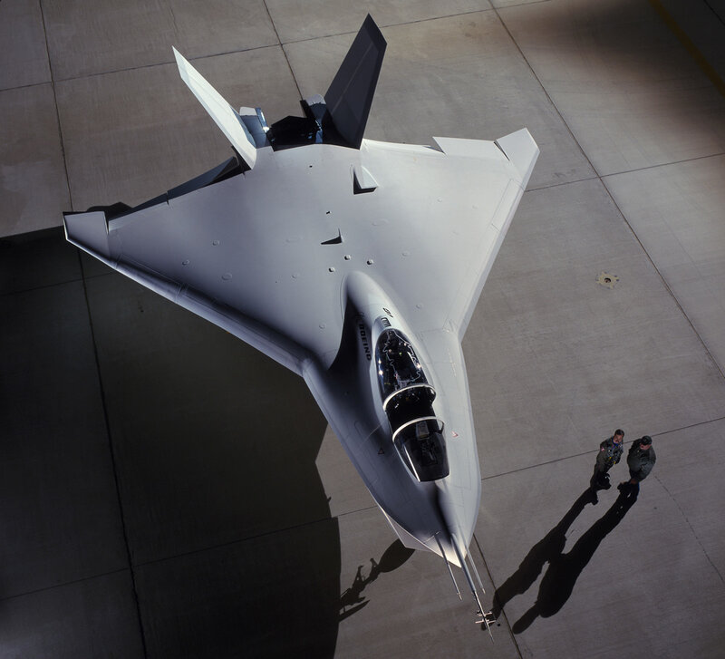 Stealth Fighter Jet — Gray, Dramatic, Afternoon, Photograph, Two People, Concrete Tarmac