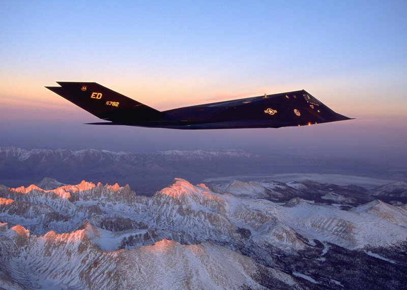 Stealth fighter over mountains
