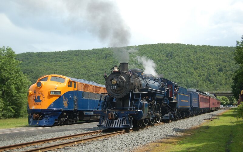 Steam and diesel trains on tracks