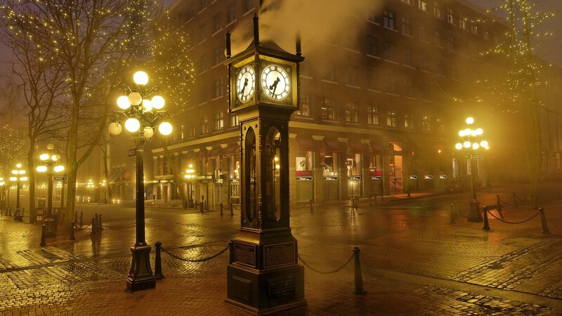 Steam clock in foggy city square