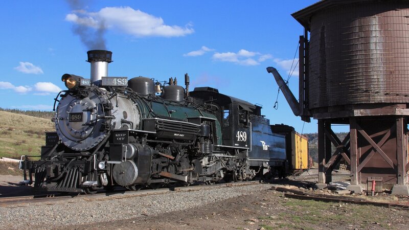Steam locomotive at a water tower