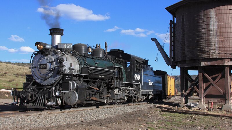 Steam locomotive at a water tower