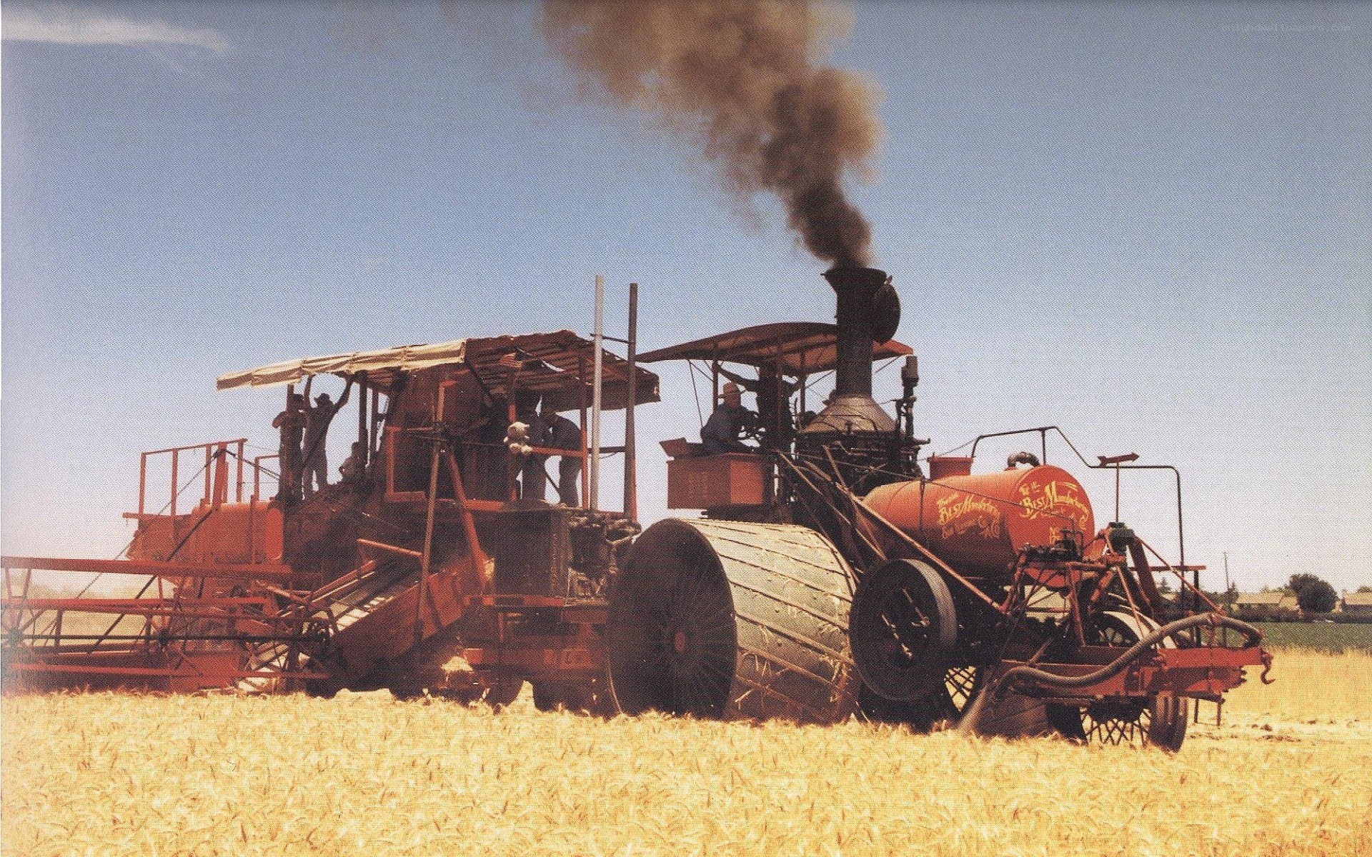 Steam-powered harvester in field