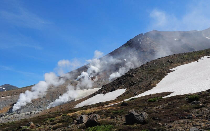 Steam rising from a volcanic slope