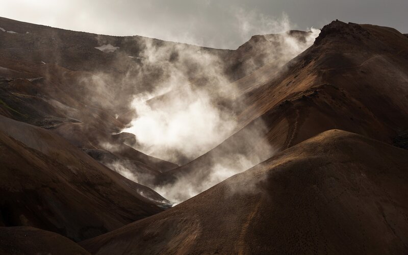 Steam rising from volcanic hills