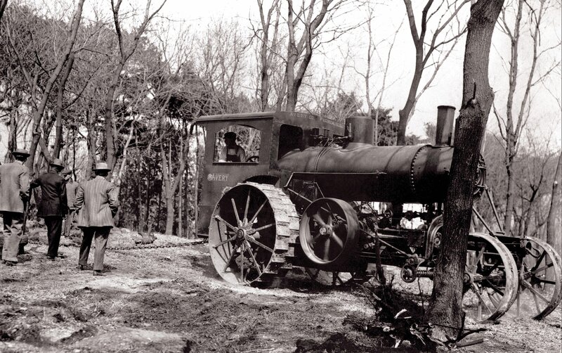 Steam tractor in forest clearing