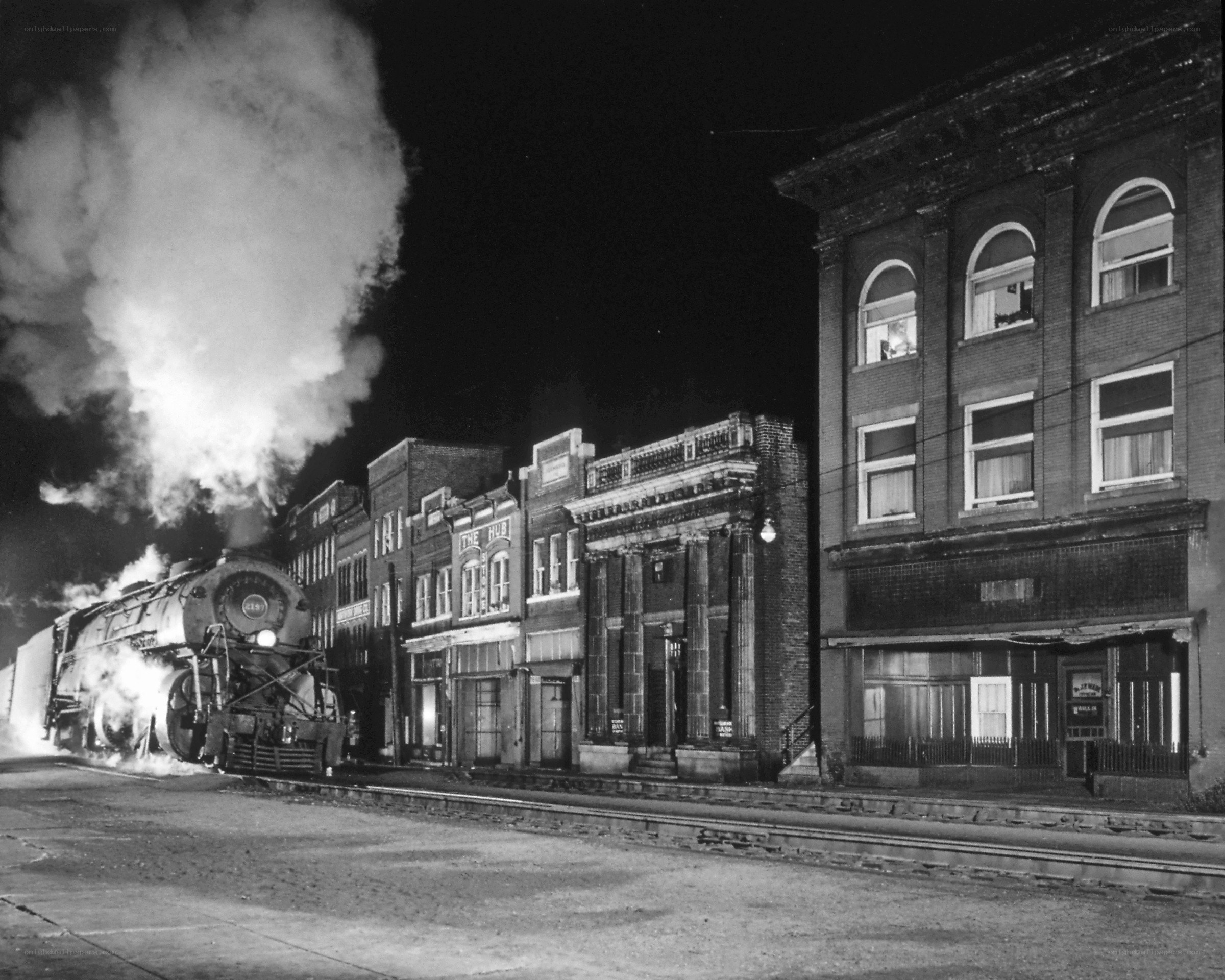 Steam train at night in town