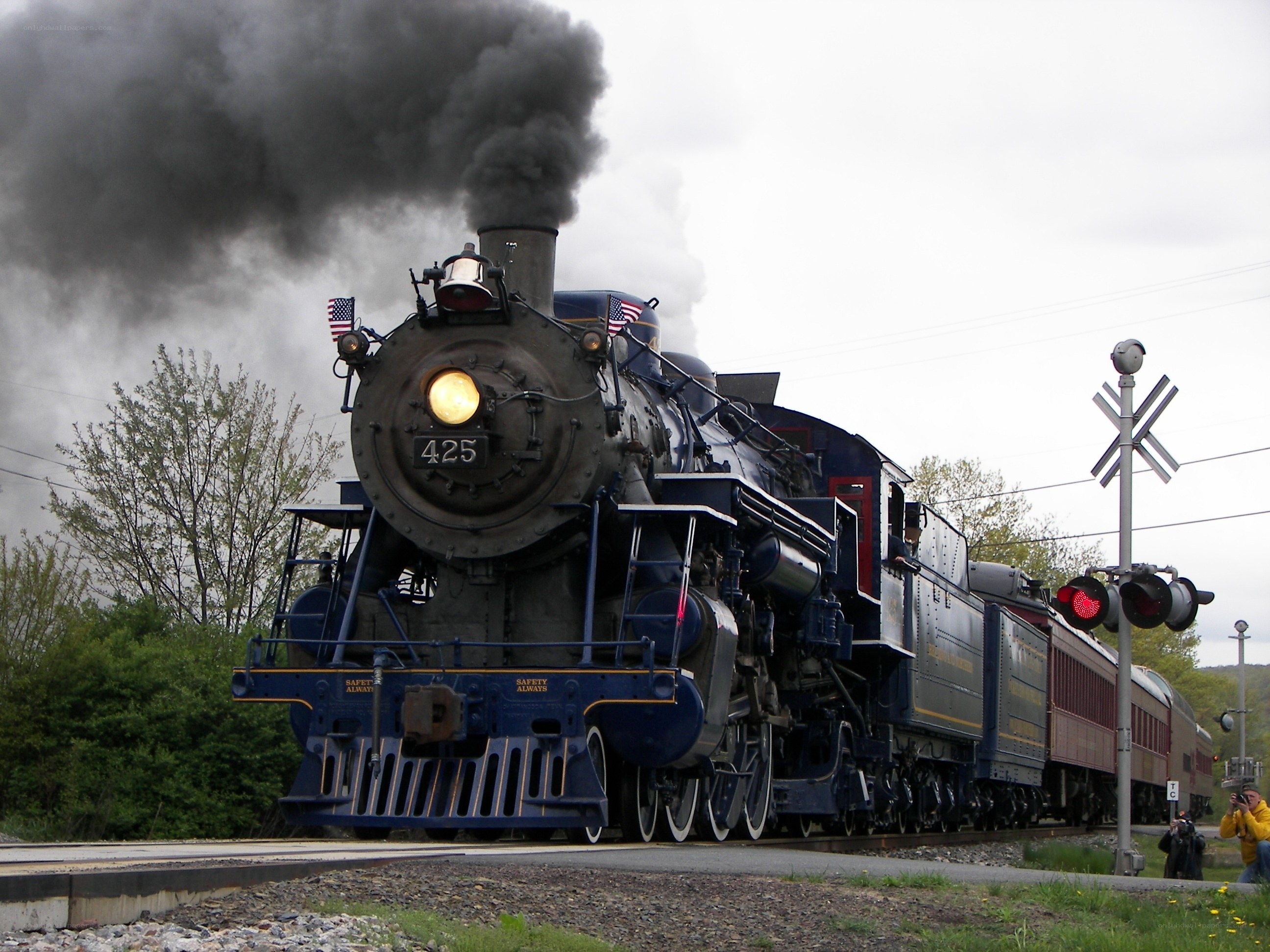 Steam train at railroad crossing