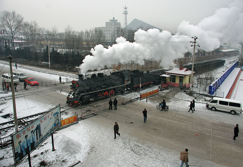 Steam train at snowy railway station