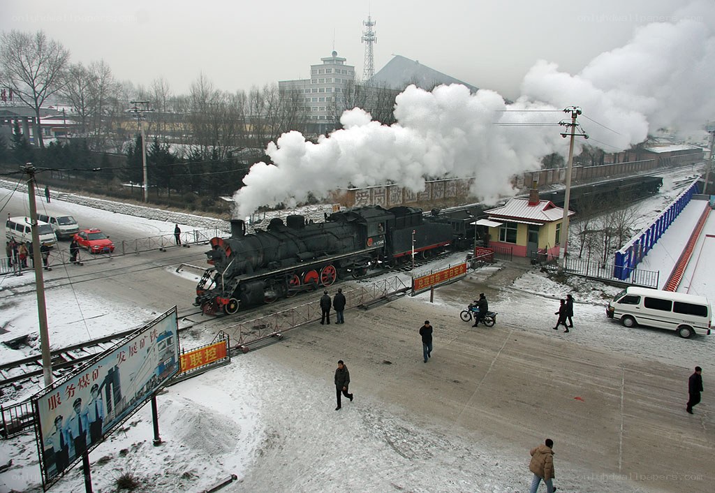 Steam train at snowy railway station